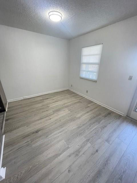 2075 Cornwall East, Unit 2075 Boca Raton, FL 33434 - Photo 6 of 32 an empty room with wooden floor and windows