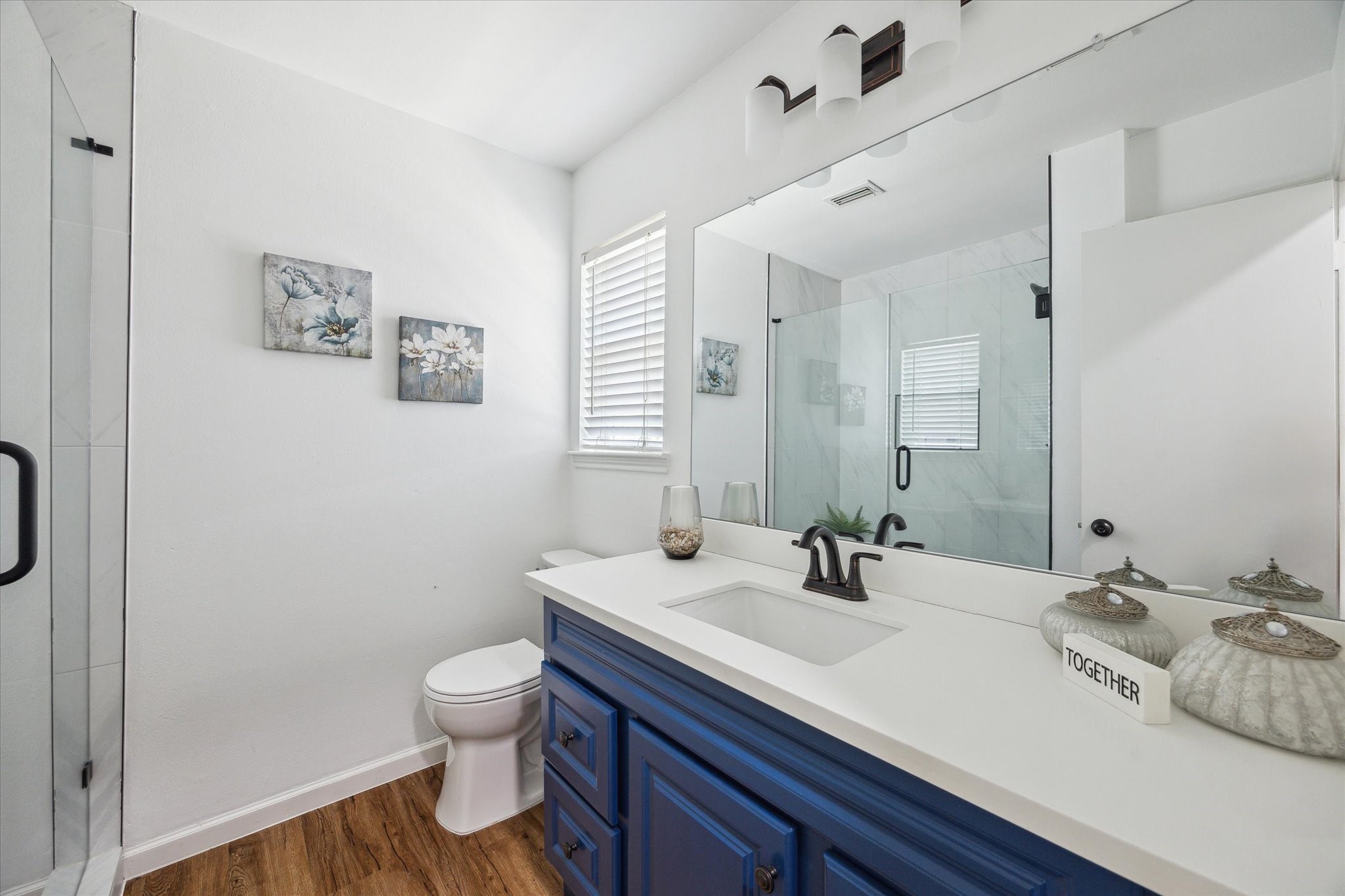 2231 Lexford Lane Houston, TX 77080 - Photo 15 of 23 a bathroom with a sink a toilet and a mirror