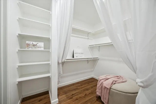 a view of walk in closet with empty racks