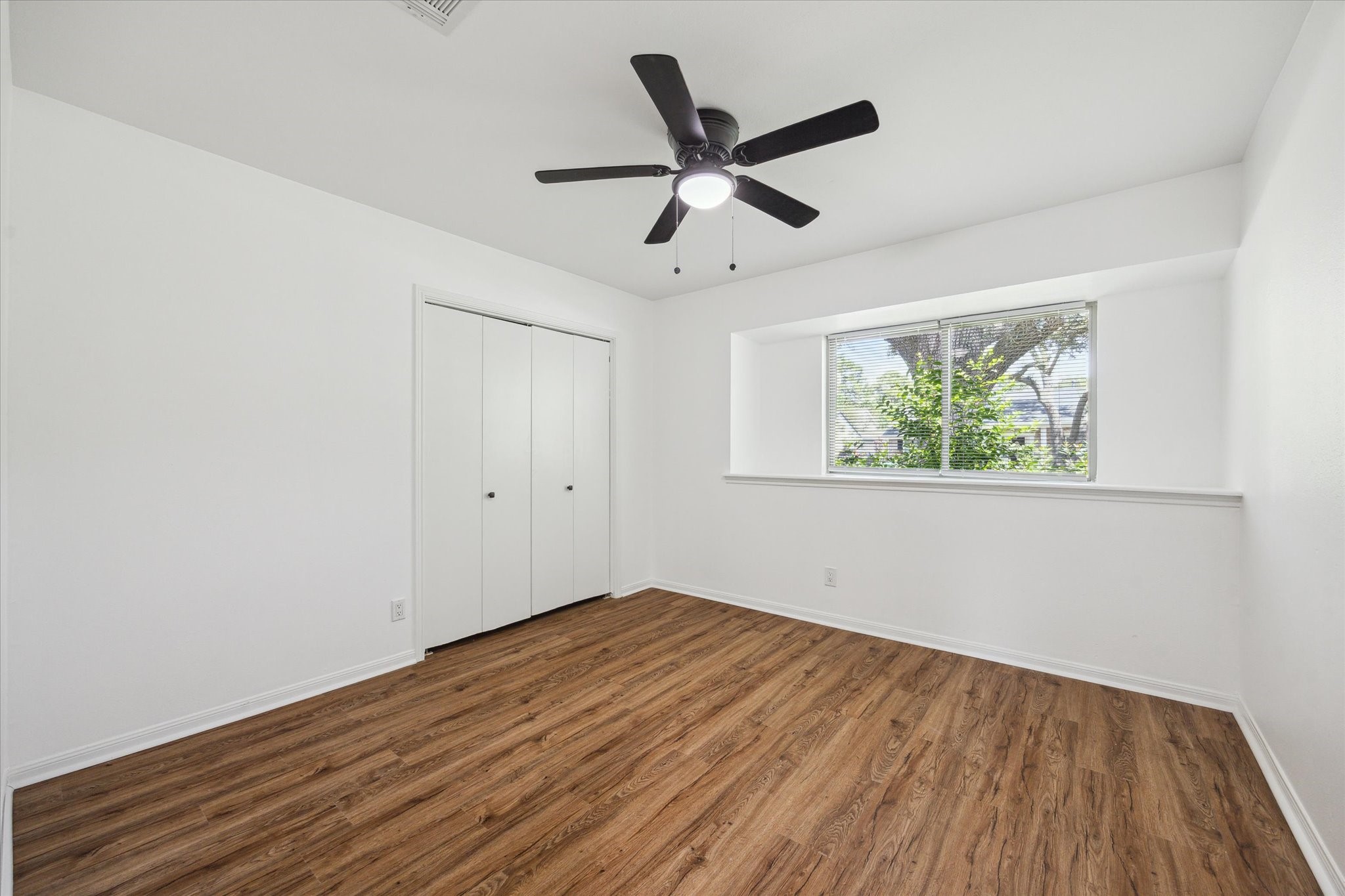 2231 Lexford Lane Houston, TX 77080 - Photo 18 of 23 a view of empty room with wooden floor and fan