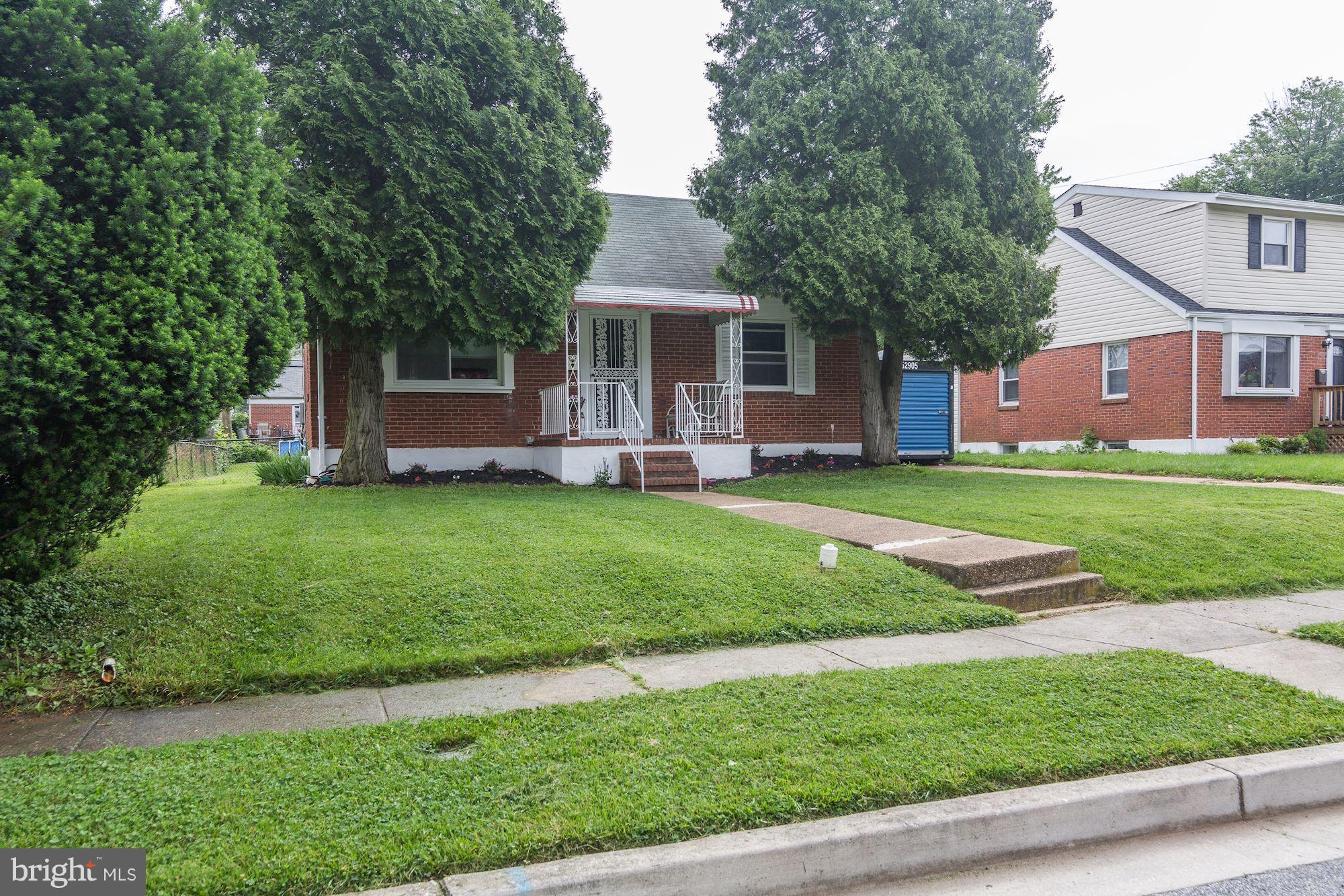 707 Silver Creek Road Baltimore, MD 21208 - Photo 3 of 30 a front view of a house with a yard and trees