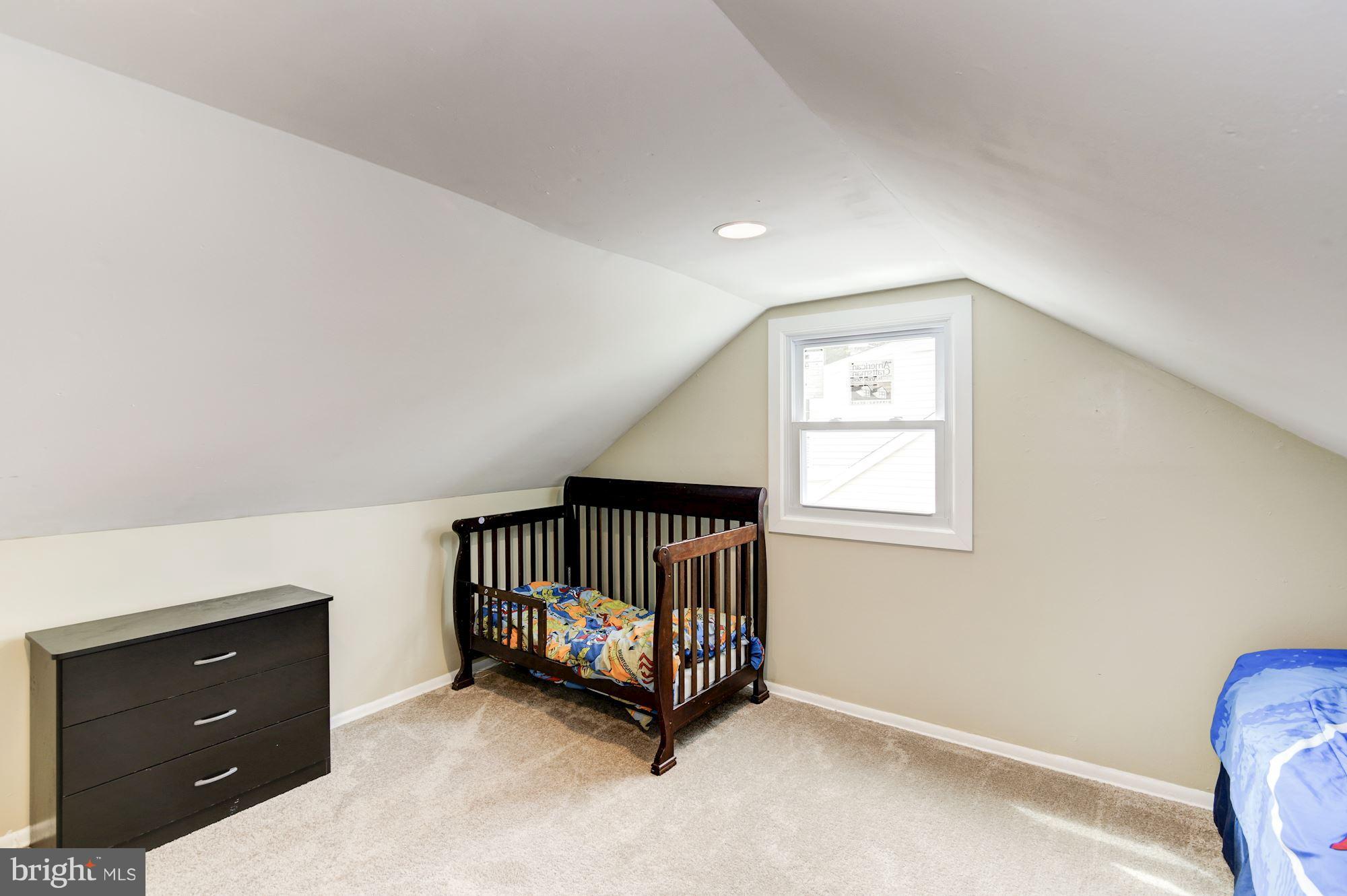 707 Silver Creek Road Baltimore, MD 21208 - Photo 22 of 30 a room with a dresser and a window