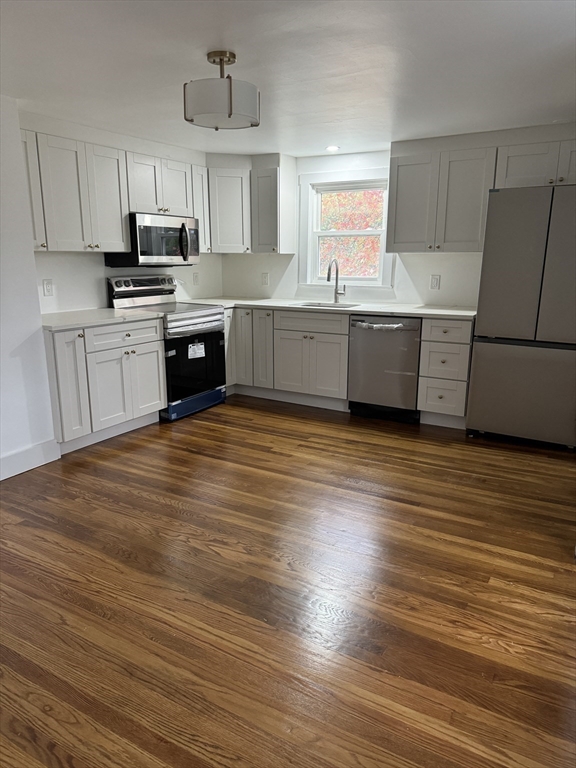 1099 South Main Street Bellingham, MA 02019 - Photo 15 of 20 a kitchen with stainless steel appliances granite countertop a sink counter space cabinets and a large window