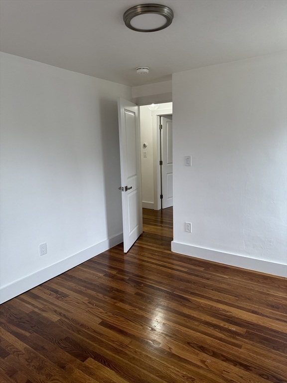 1099 South Main Street Bellingham, MA 02019 - Photo 19 of 20 a view of an empty room with wooden floor and a window