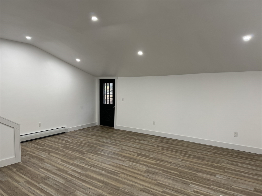 1099 South Main Street Bellingham, MA 02019 - Photo 6 of 20 an empty room with wooden floor and windows