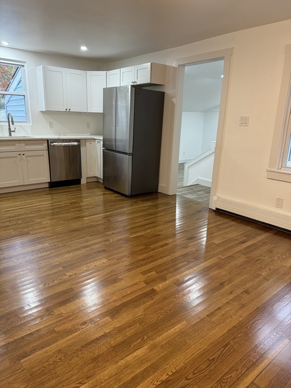 1099 South Main Street Bellingham, MA 02019 - Photo 8 of 20 a view of a kitchen with wooden floor and stainless steel appliances