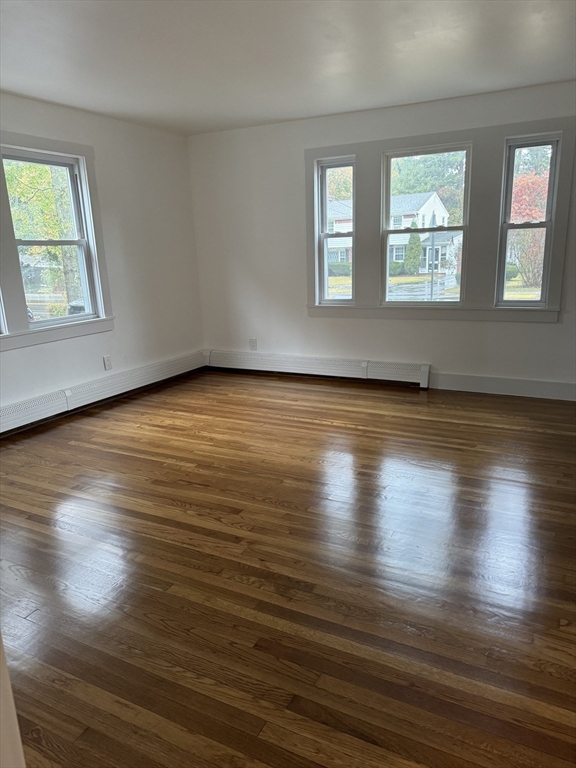 1099 South Main Street Bellingham, MA 02019 - Photo 10 of 20 an empty room with wooden floor and windows