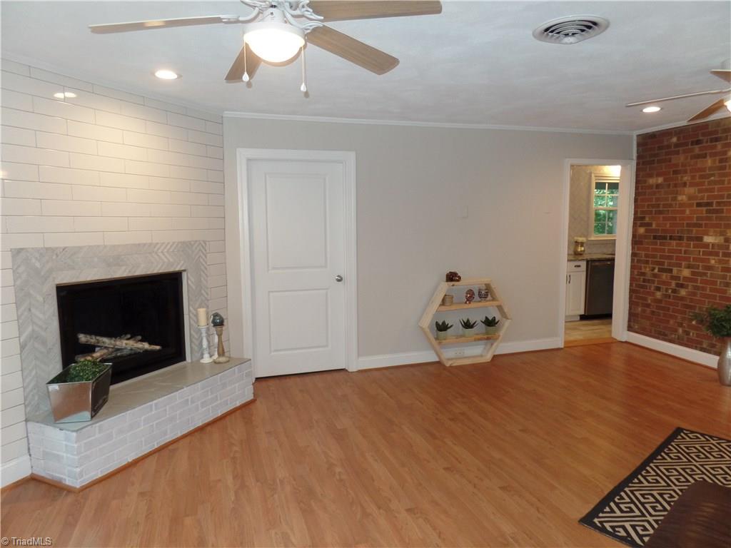 2995 Dillon Road Jamestown, NC 27282 - Photo 3 of 30 Tiled fireplace with laundry room off den.