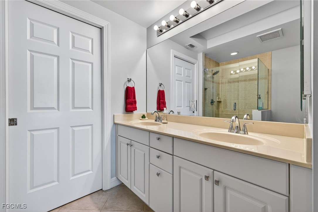 2743 First Street, Unit 502 Fort Myers, FL 33916 - Photo 17 of 39 a bathroom with a double vanity sink and a mirror