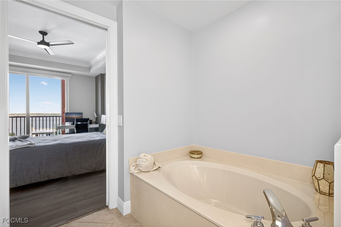 2743 First Street, Unit 502 Fort Myers, FL 33916 - Photo 18 of 39 a bathroom with a bathtub and a window