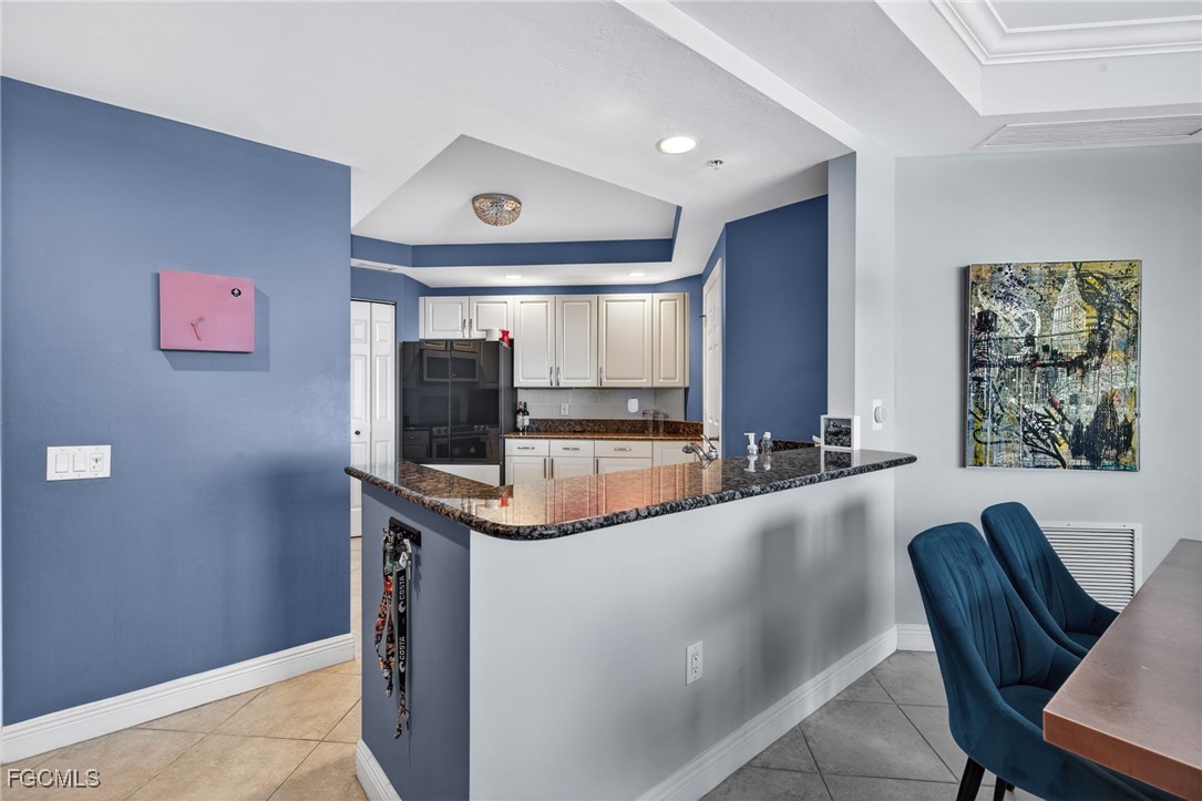 2743 First Street, Unit 502 Fort Myers, FL 33916 - Photo 8 of 39 a living room with stainless steel appliances kitchen island granite countertop furniture and a large window