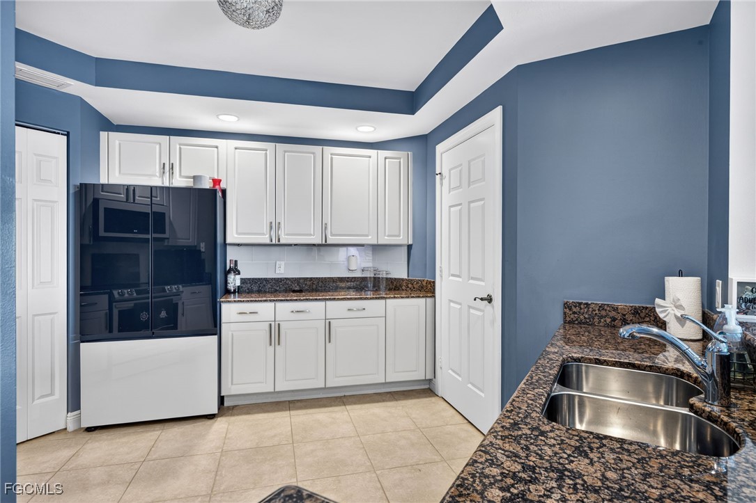 2743 First Street, Unit 502 Fort Myers, FL 33916 - Photo 9 of 39 a kitchen with stainless steel appliances granite countertop a refrigerator and a stove