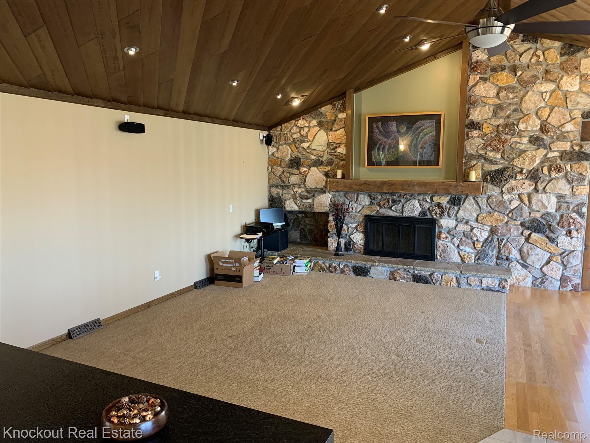 9252 Ormes Road Vassar, MI 48768 - Photo 16 of 64 Great room with natural fireplace and statement stone wall