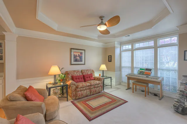 a living room with furniture and a potted plant