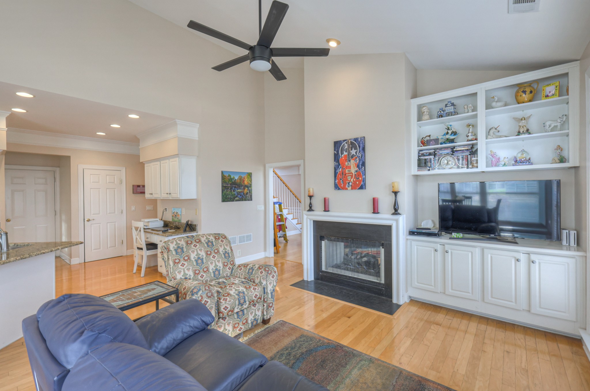 6331 Williams Grove Drive Brentwood, TN 37027 - Photo 32 of 58 a living room with furniture a flat screen tv and a fireplace