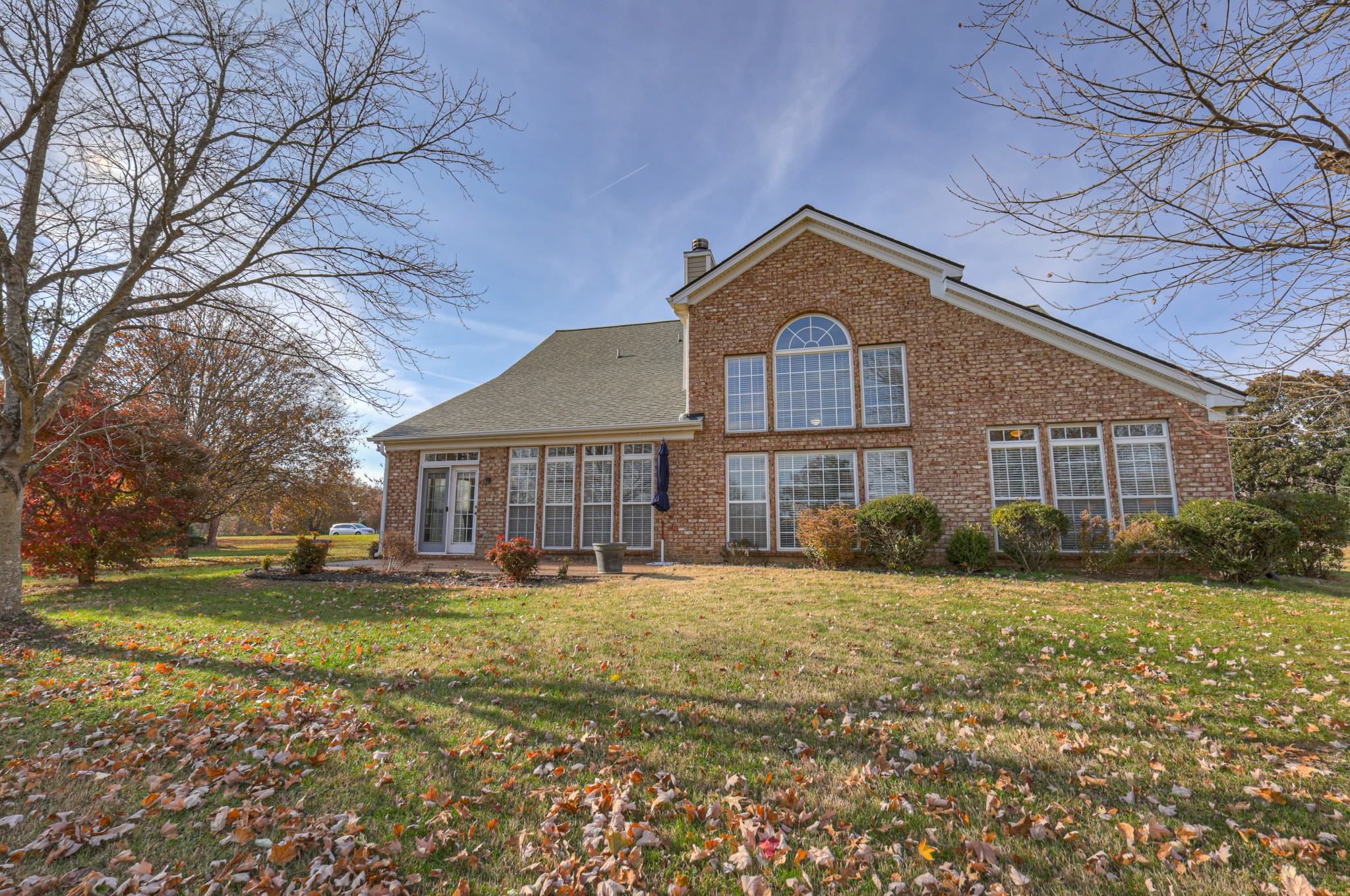 6331 Williams Grove Drive Brentwood, TN 37027 - Photo 55 of 58 a view of a yard in front of a brick house with a large tree