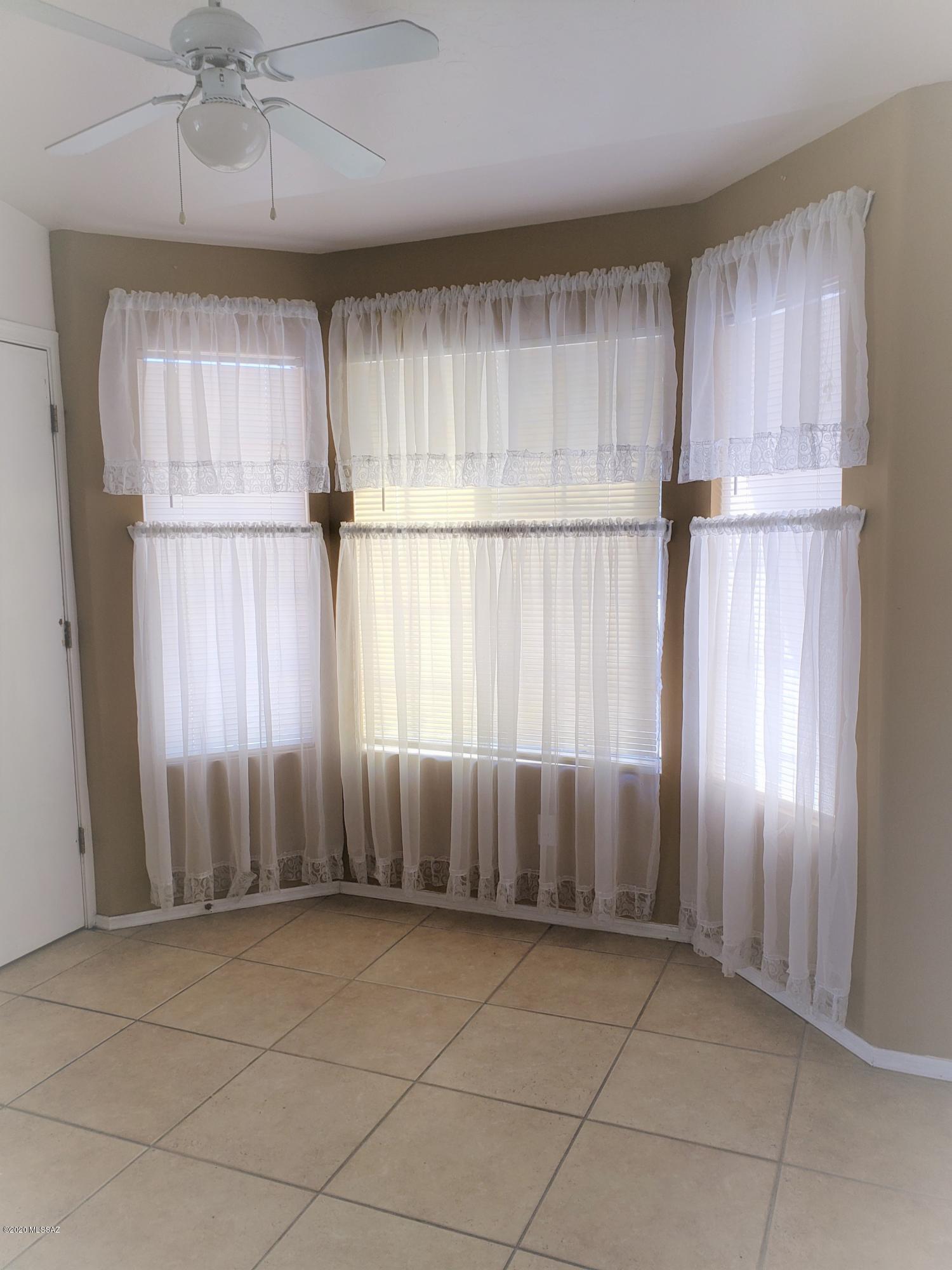 1200 Desert Dawn Drive Rio Rico, AZ 85648 - Photo 6 of 24 an empty room with a window and a ceiling fan