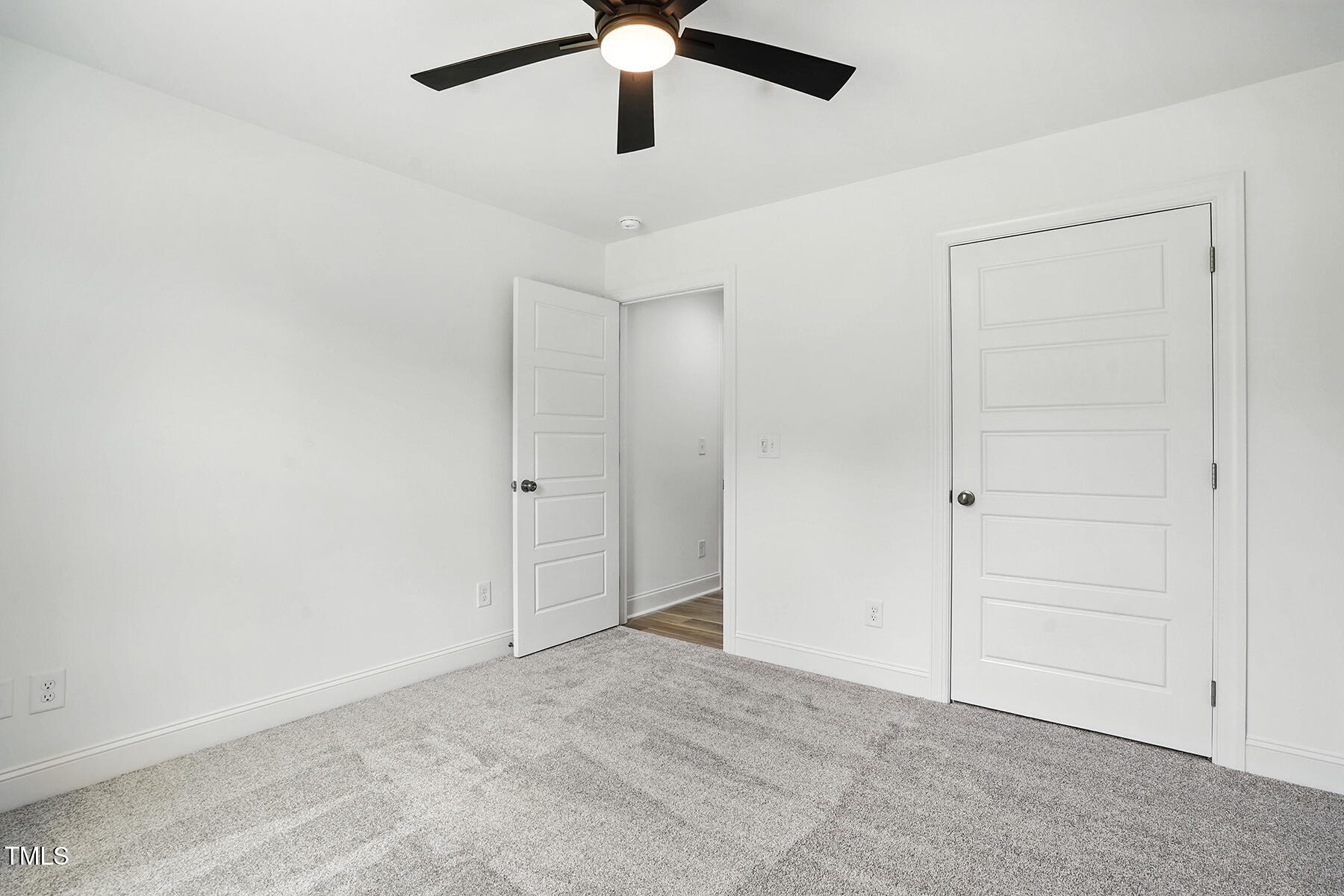 8708 Green Path Road Dunn, NC 28334 - Photo 16 of 31 an empty room with a ceiling fan and carpet