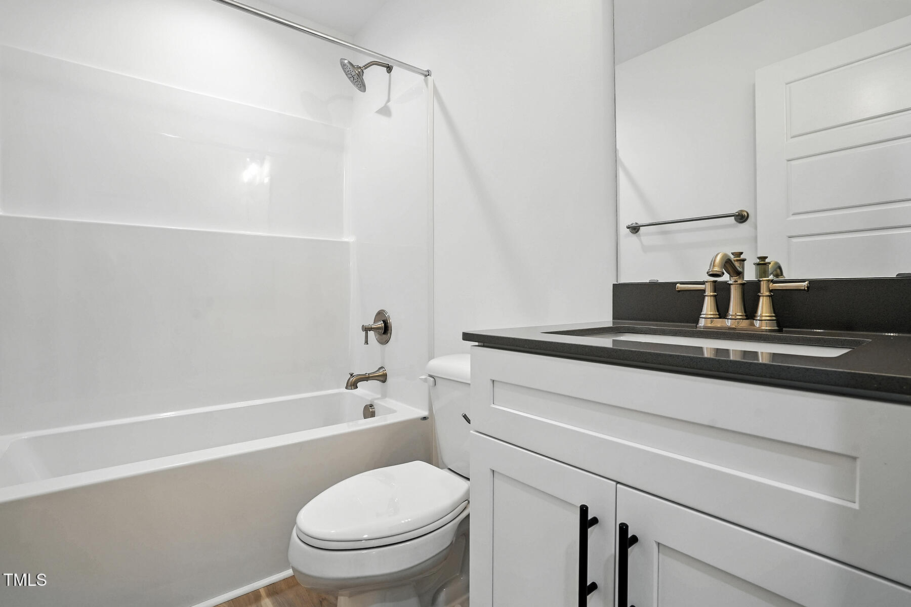 8708 Green Path Road Dunn, NC 28334 - Photo 17 of 31 a bathroom with a sink a toilet and a bathtub