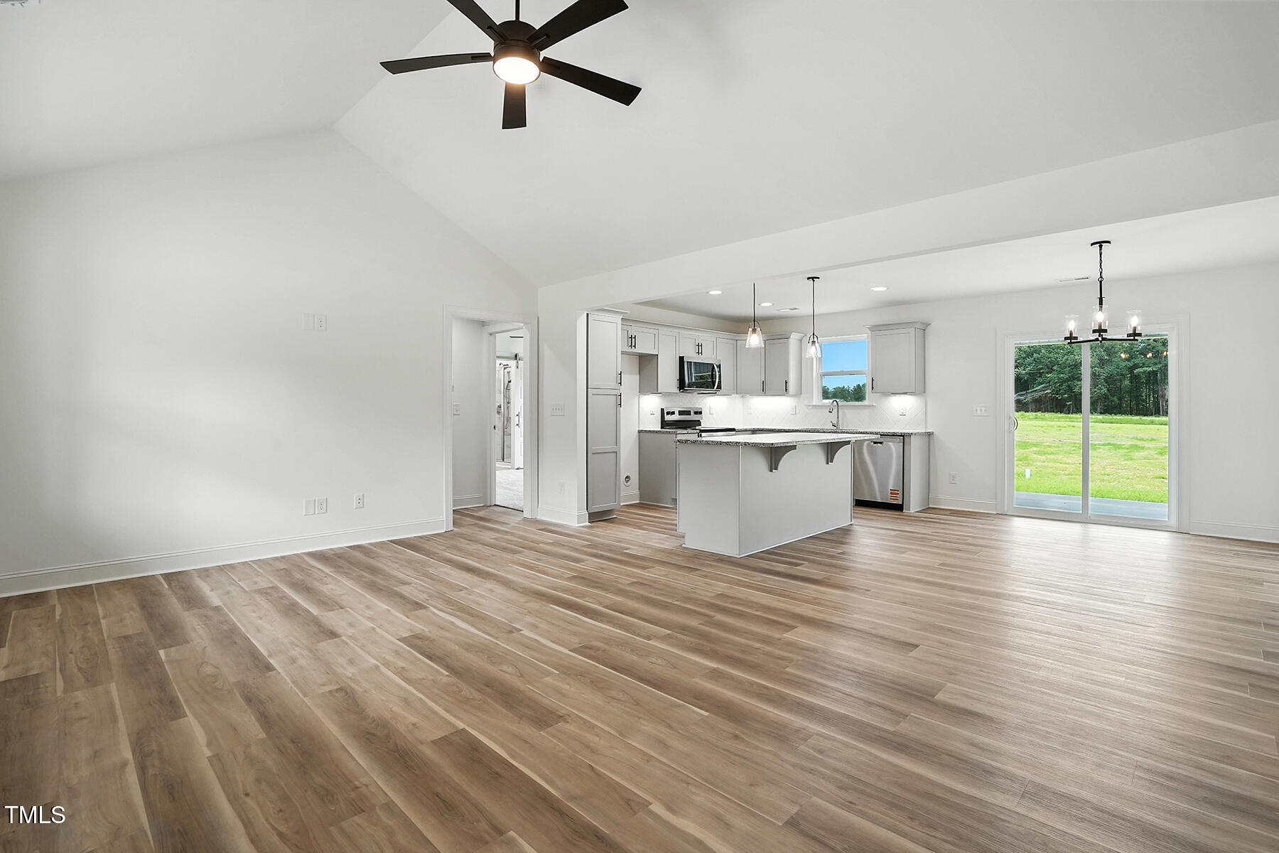 8708 Green Path Road Dunn, NC 28334 - Photo 5 of 31 a view of a kitchen with a sink a dishwasher and wooden floor