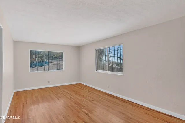 a view of a kitchen with wooden floor and electronic appliances