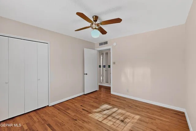 a view of a livingroom with a staircase and a ceiling fan