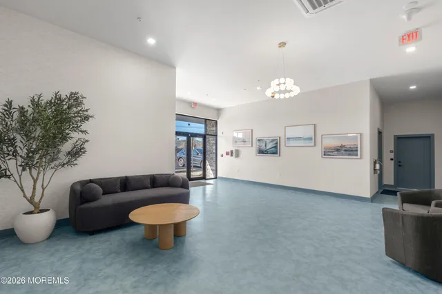 a living room with furniture and a chandelier