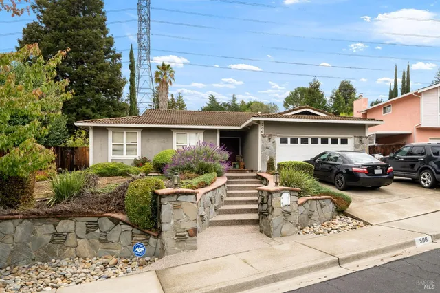 a view of a car park in front of house