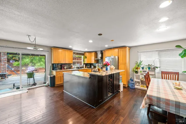 a kitchen with a sink and wooden floor