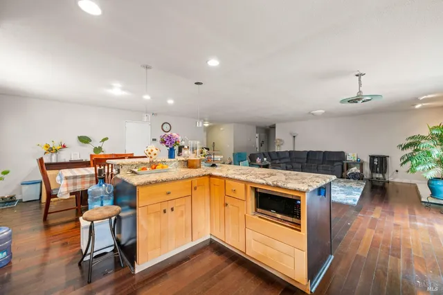 a living room with lots of furniture and kitchen view