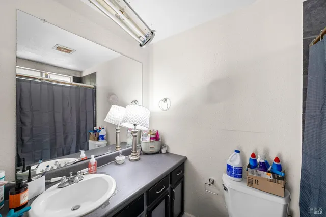 a bedroom with a large bed and a tv