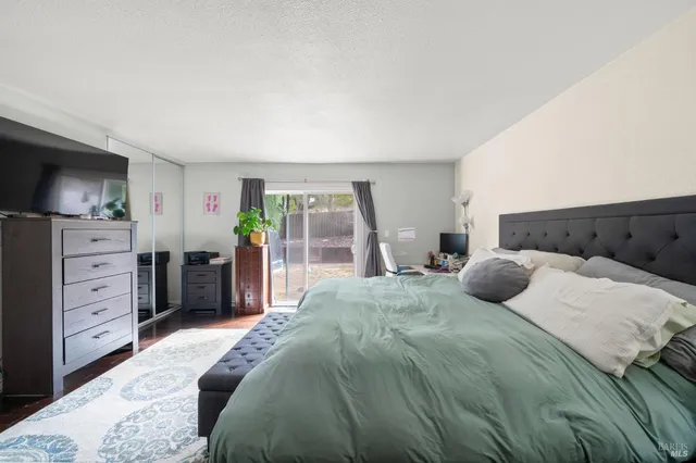 a bedroom with a bed table and a window