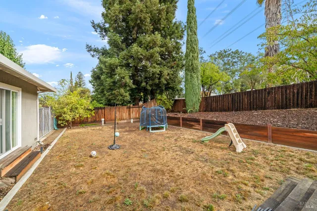 a view of a house with backyard and sitting area