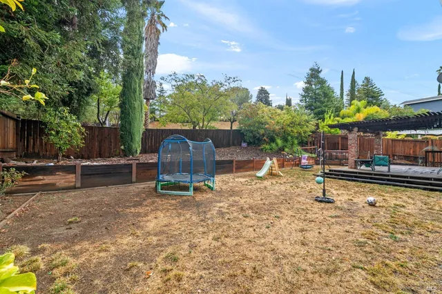 a backyard of a house with table and chairs