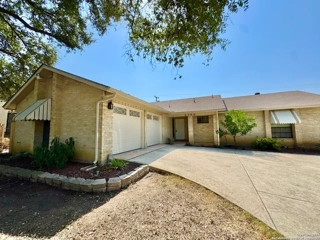 a view of empty room with a fireplace and wooden floor