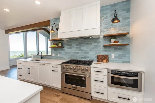 a kitchen with a stove and white cabinets