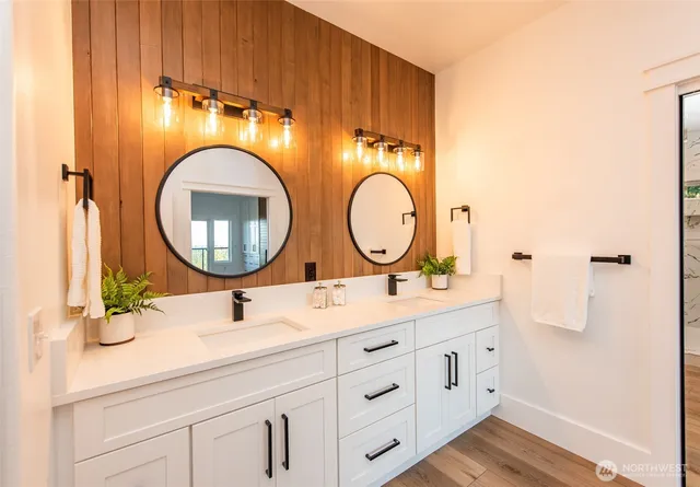 a bathroom with a double vanity sink and a mirror