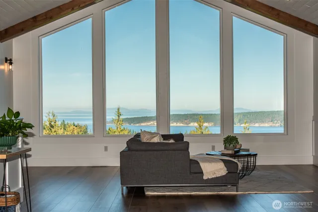 a view of a living room with furniture and window