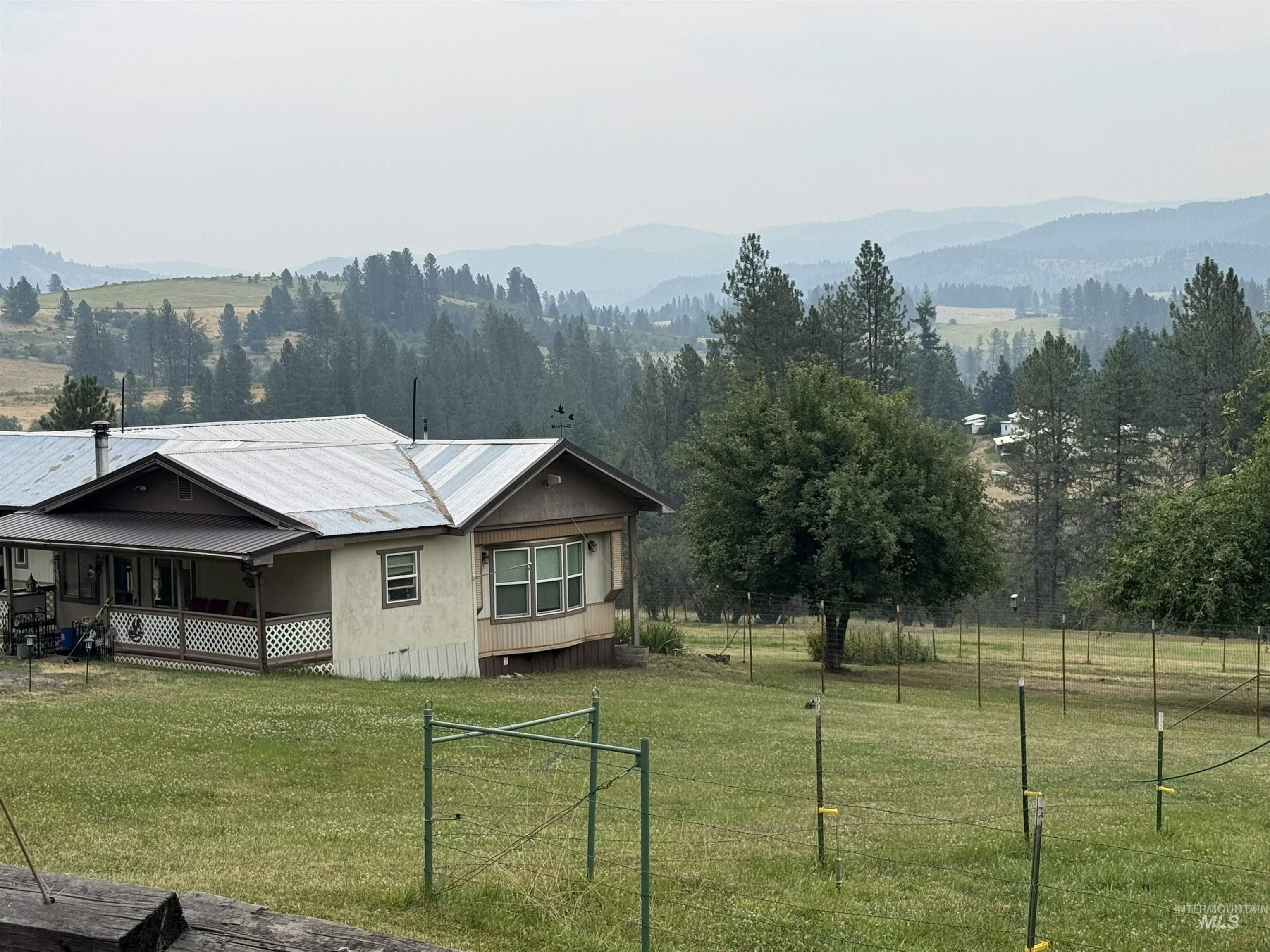 733 Pleasant Valley Road Stites, ID 83552 - Photo 4 of 46 Covered porch with lattice accents, a metal roof, and a bay window