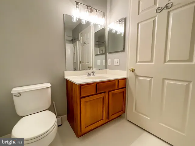 a bathroom with a toilet a sink and mirror