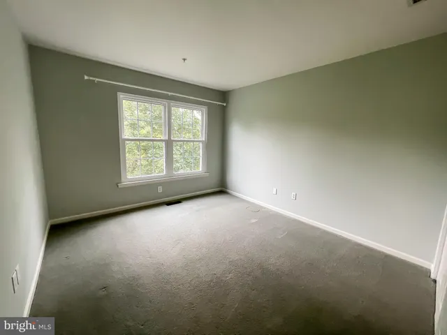 an empty room with a empty space and a window