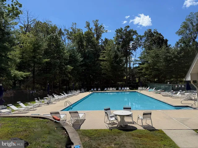 a swimming pool with outdoor seating and yard