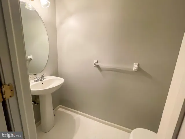 a bathroom with a sink a toilet and mirror