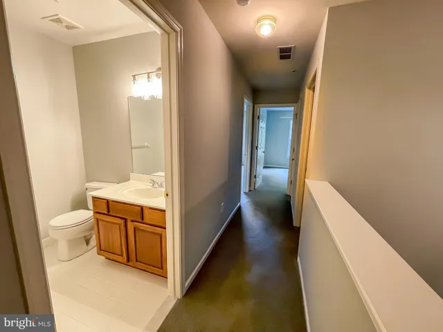 a bathroom with a sink a toilet and vanity