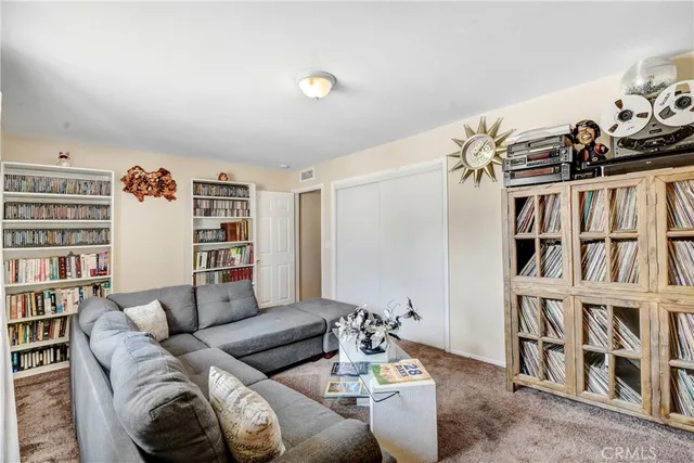 a living room with furniture and a book shelf