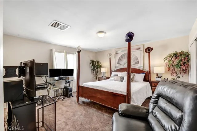 a bedroom with a bed gym equipment and a large window