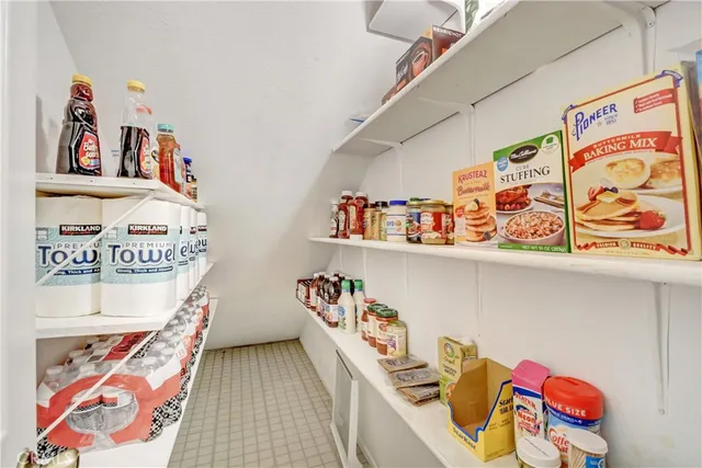 a view of a hallway with paintings on the wall