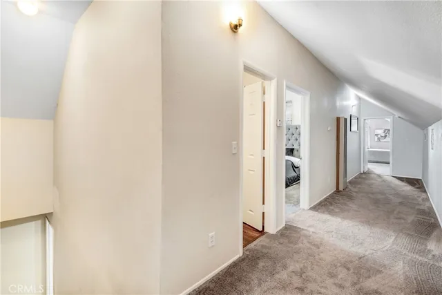 a view of a hallway with wooden shelves