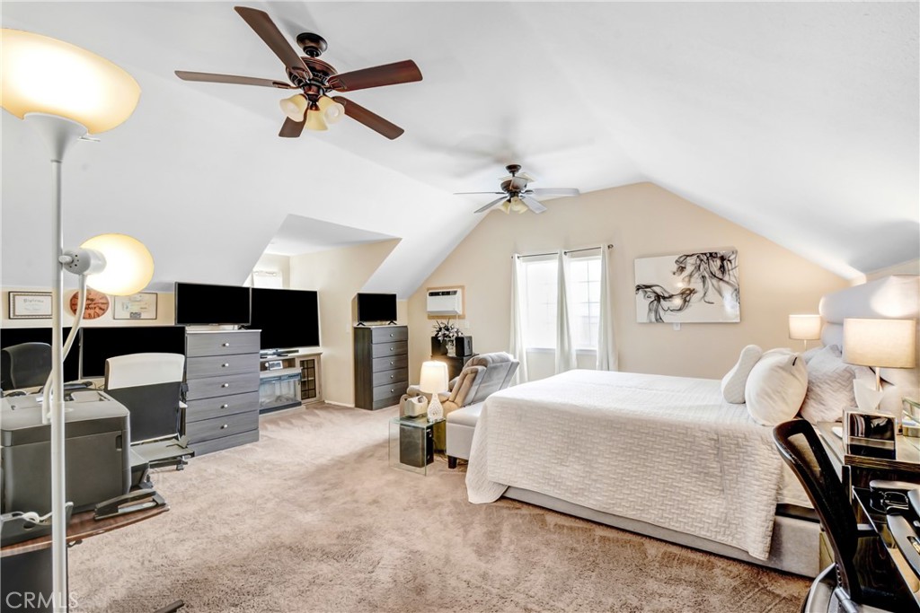 10015 High Road Lucerne Valley, CA 92356 - Photo 27 of 39 a bedroom with a bed gym equipment and a fireplace