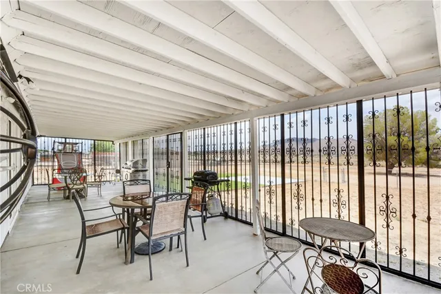 a dining room with furniture and a floor to ceiling window